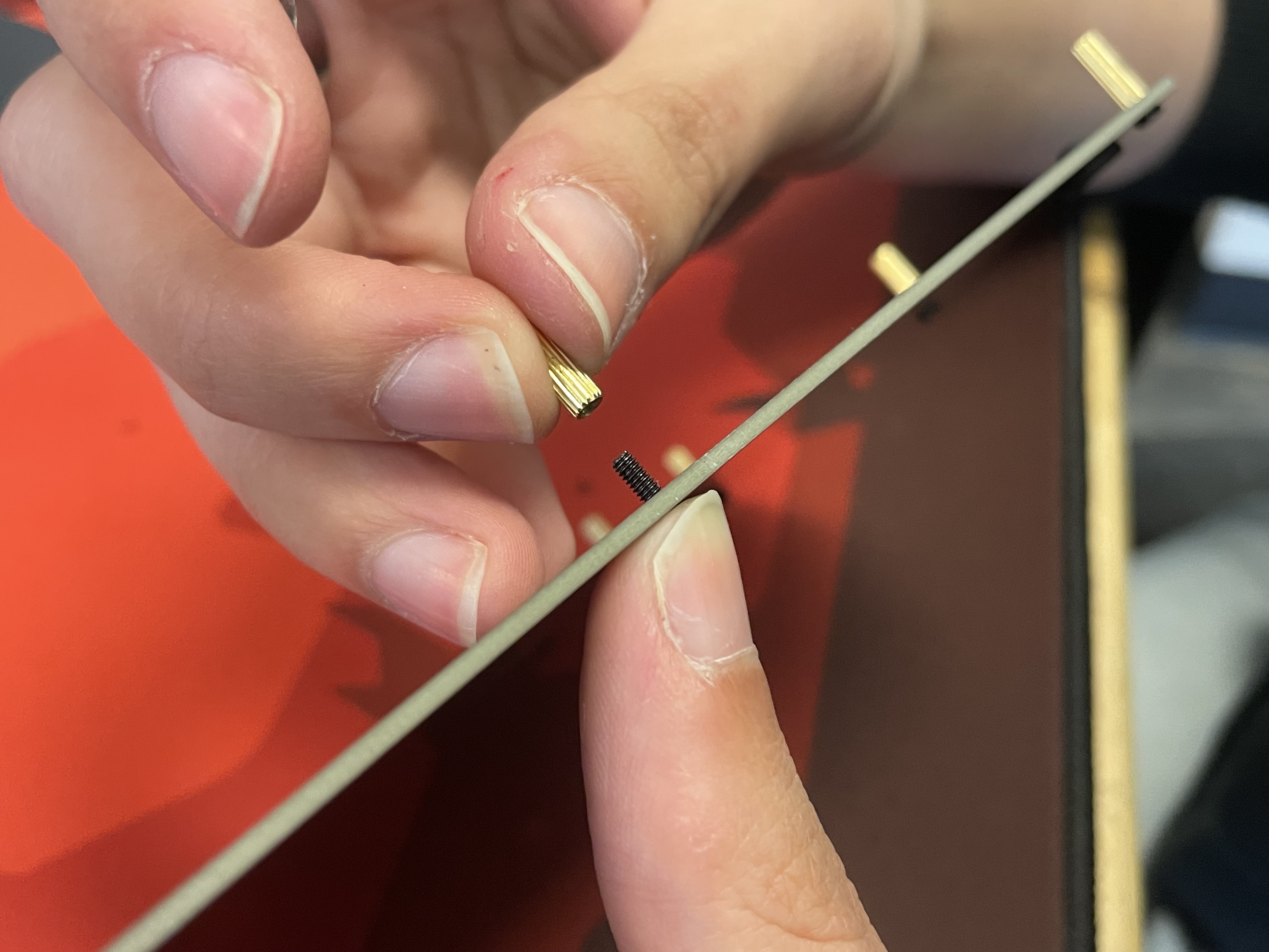 Inserting screw to attach standoff